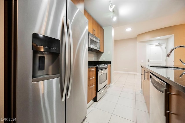 200 W Sahara Ave Unit 1510, Las Vegas, NV 89102 - kitchen with appliances with stainless steel finishes, brown cabinets, light tile patterned flooring, modern cabinets, and recessed lighting