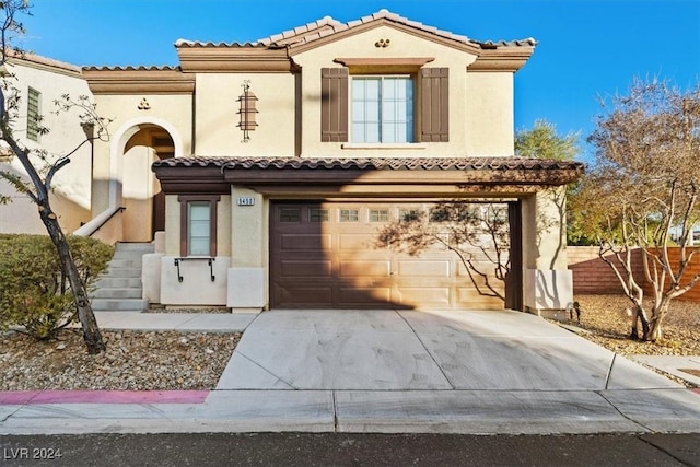 mediterranean / spanish-style house with a garage