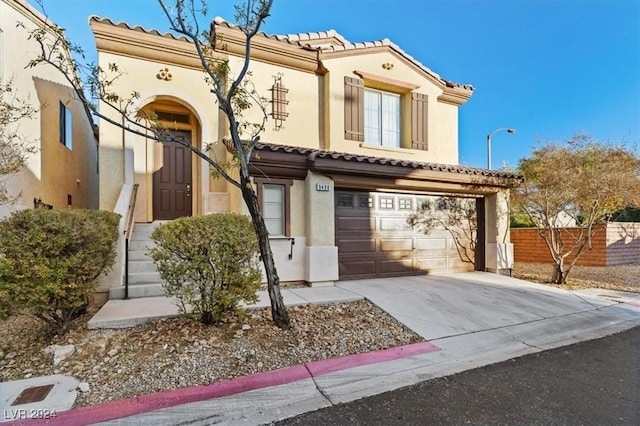 mediterranean / spanish-style home with a garage