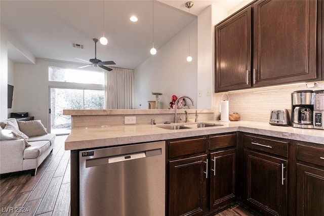 kitchen with dishwasher, kitchen peninsula, sink, and decorative light fixtures