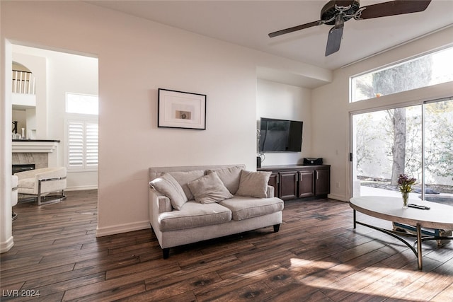 living room with dark hardwood / wood-style floors, ceiling fan, and a wealth of natural light