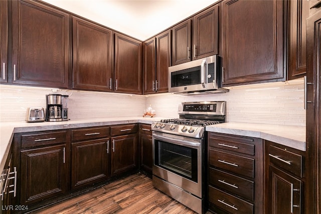 kitchen featuring decorative backsplash, appliances with stainless steel finishes, dark hardwood / wood-style flooring, and dark brown cabinets