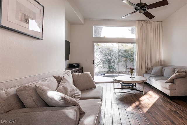 living room with dark hardwood / wood-style flooring and ceiling fan