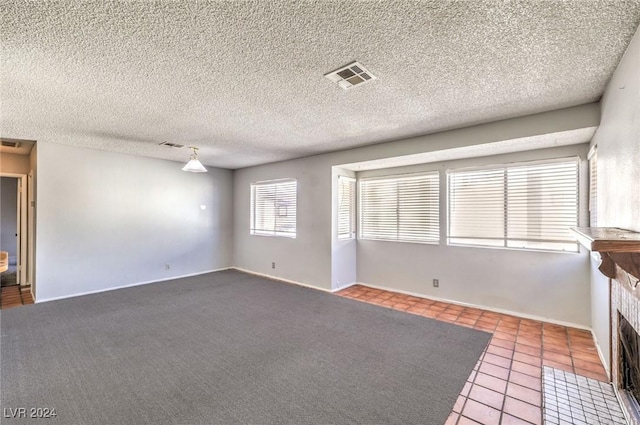 interior space with a fireplace, a textured ceiling, and tile patterned flooring