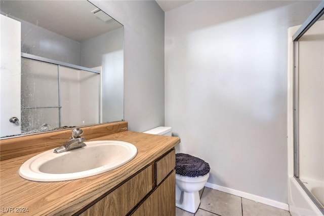 full bathroom with tile patterned flooring, combined bath / shower with glass door, toilet, and vanity