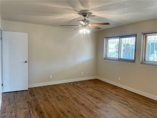 unfurnished room featuring dark hardwood / wood-style flooring and ceiling fan