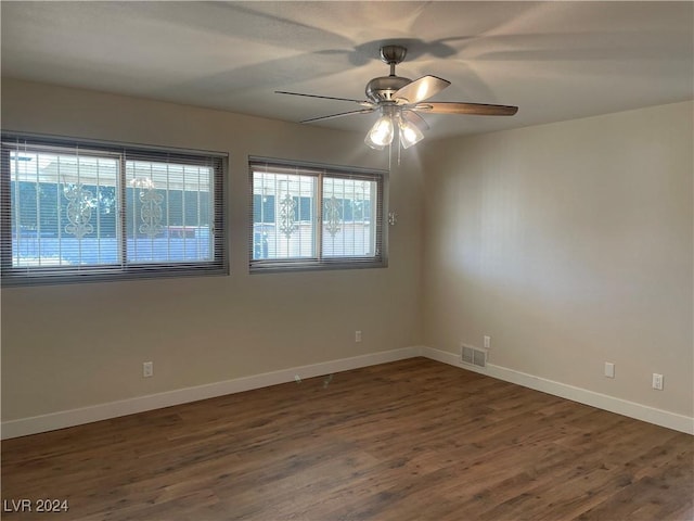 empty room featuring ceiling fan and dark wood-type flooring