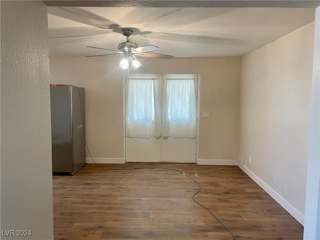 spare room with hardwood / wood-style floors and ceiling fan