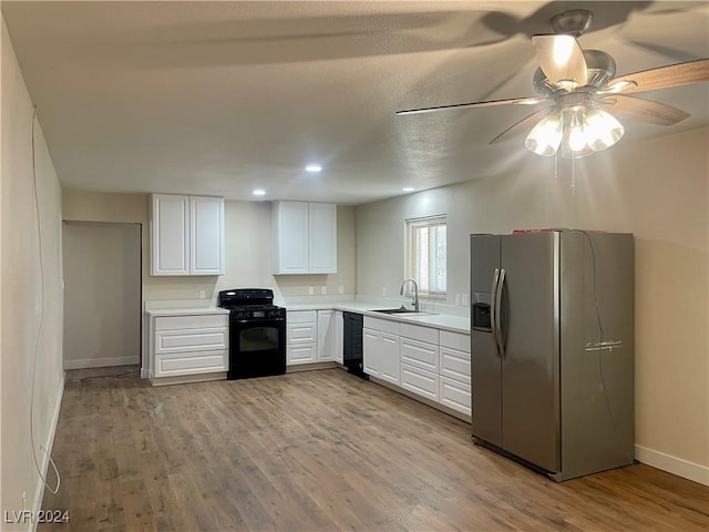 kitchen featuring white cabinetry, sink, black appliances, and light wood-type flooring