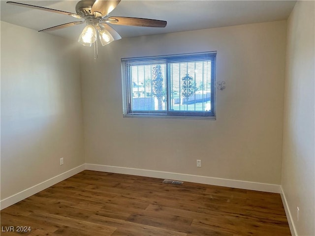 empty room featuring ceiling fan and dark wood-type flooring