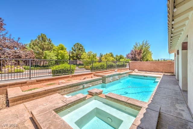 view of pool featuring an in ground hot tub