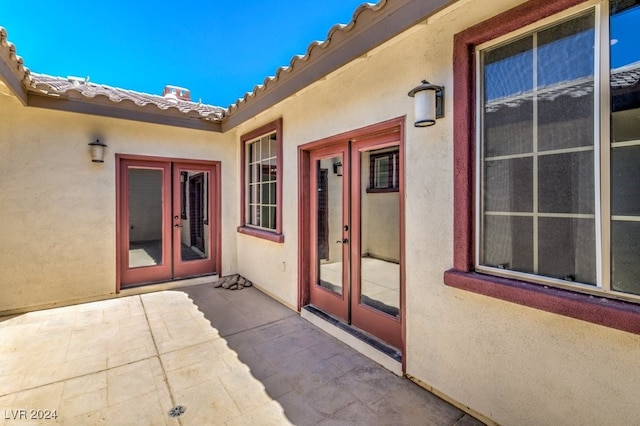 entrance to property featuring a patio and french doors