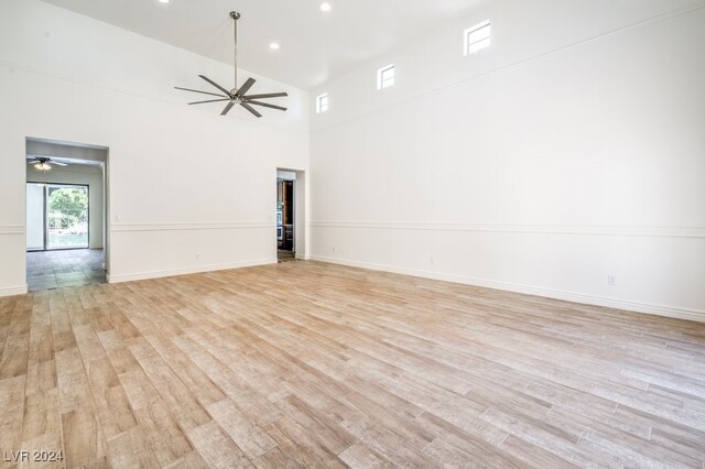 empty room featuring light hardwood / wood-style flooring and high vaulted ceiling