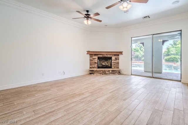 unfurnished living room featuring a fireplace, light wood-type flooring, ceiling fan, and crown molding