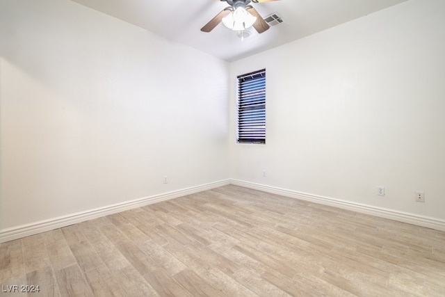 spare room featuring light hardwood / wood-style flooring and ceiling fan