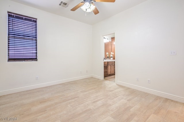 empty room featuring ceiling fan and light hardwood / wood-style floors