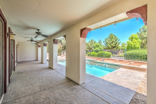 view of pool with ceiling fan and a patio area