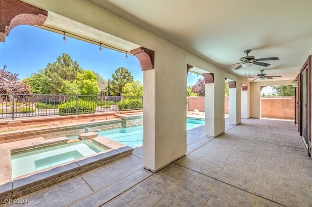 view of pool featuring an in ground hot tub, a patio, and ceiling fan