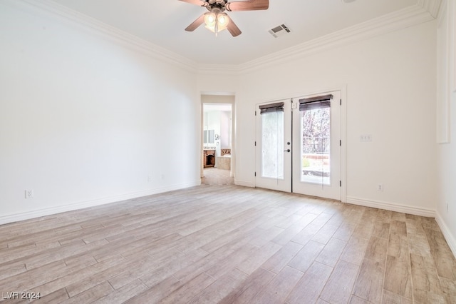 spare room featuring french doors, light wood-type flooring, and crown molding