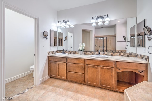 bathroom featuring tile patterned floors, vanity, toilet, and walk in shower