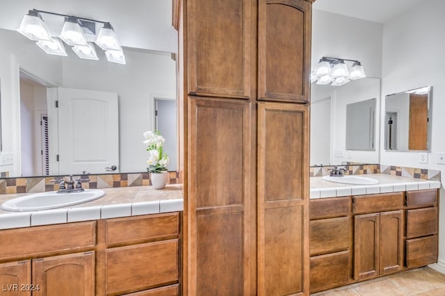 bathroom featuring tile patterned flooring and vanity