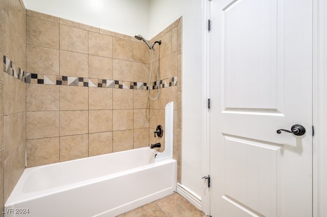 bathroom featuring tile patterned flooring and tiled shower / bath