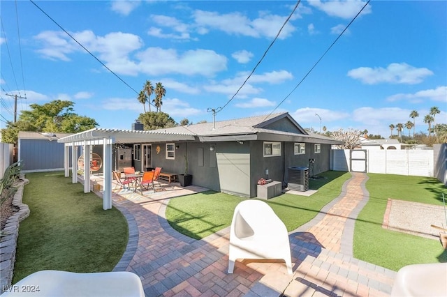 back of property with a pergola, central air condition unit, a lawn, and a patio