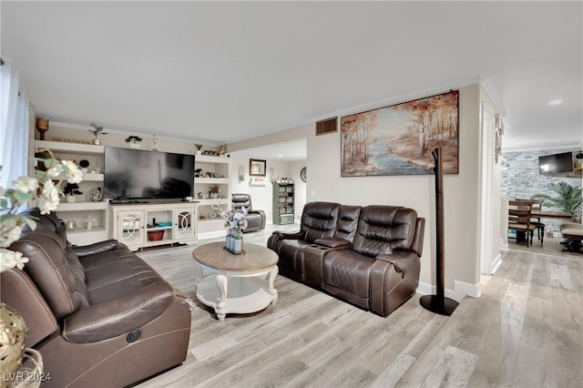 living room featuring light hardwood / wood-style floors and built in features