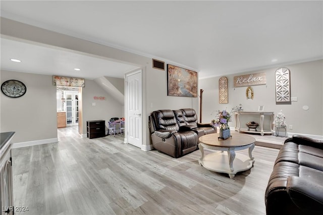 living room featuring crown molding and hardwood / wood-style floors