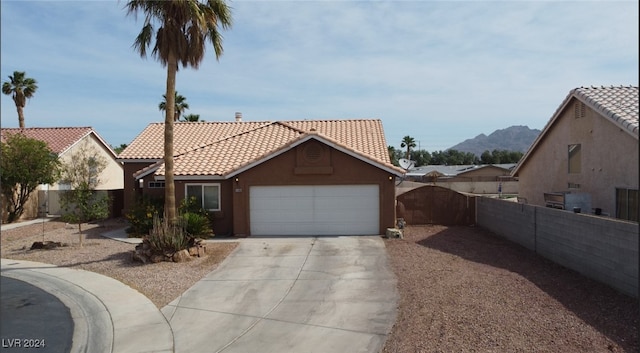 view of front facade featuring a mountain view and a garage