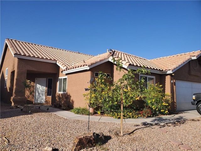 mediterranean / spanish-style house featuring a garage