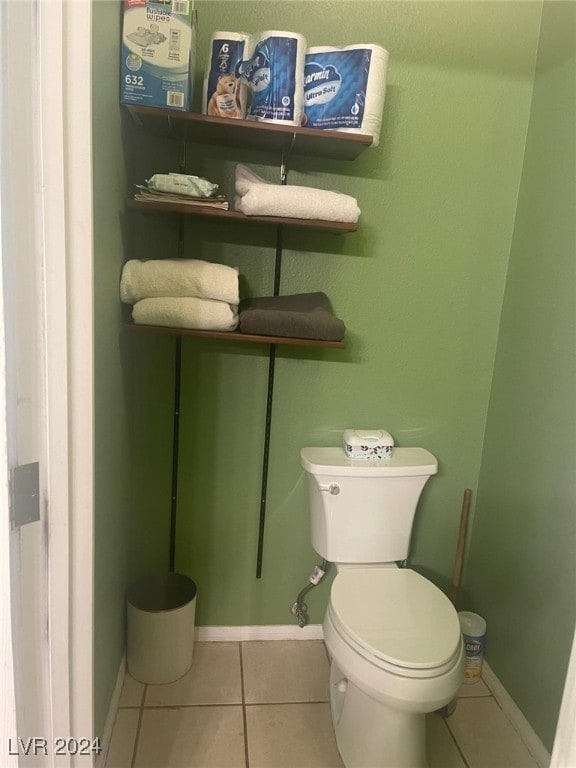 bathroom with toilet and tile patterned floors