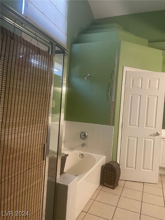 bathroom featuring tile patterned flooring and a bath