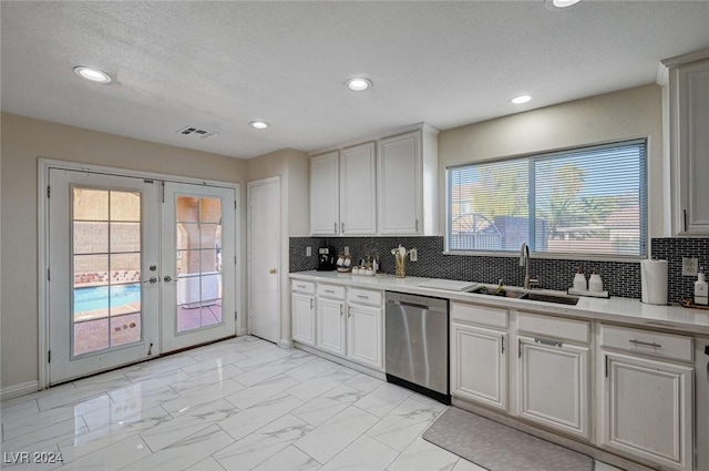 kitchen with white cabinetry, dishwasher, a healthy amount of sunlight, and french doors