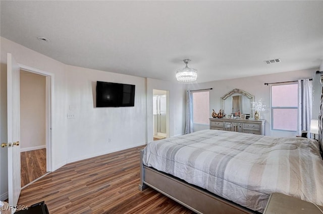 bedroom with dark hardwood / wood-style floors and ensuite bath