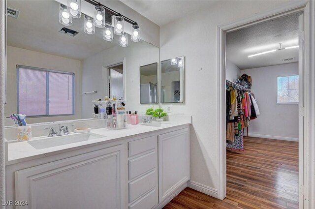 bathroom featuring vanity, a textured ceiling, and hardwood / wood-style flooring