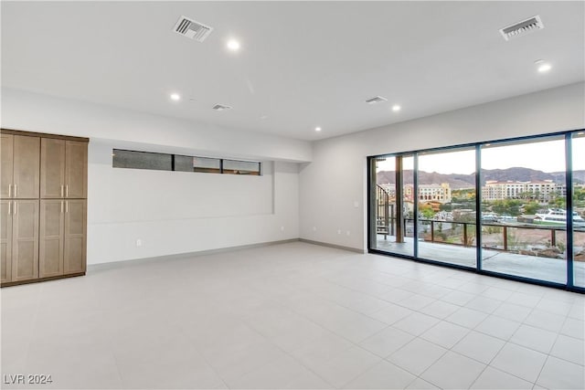 unfurnished room featuring a mountain view