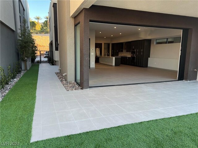 view of patio / terrace featuring a garage and a sink