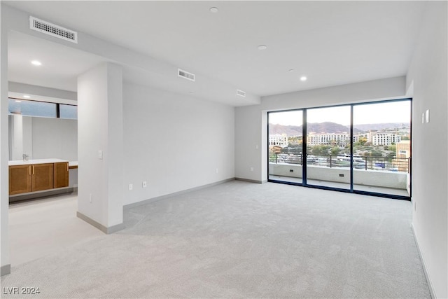 empty room featuring light colored carpet