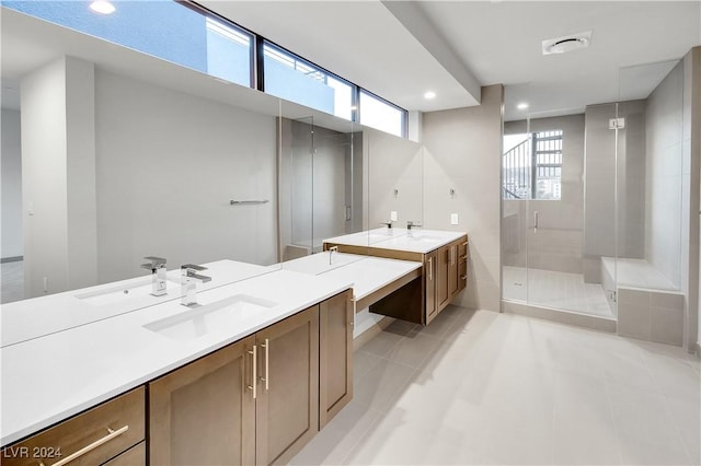 bathroom with tile patterned floors, an enclosed shower, and vanity