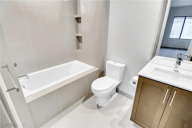 bathroom featuring tile patterned floors, a sink, toilet, and double vanity