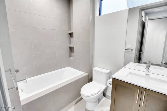 full bath with toilet, tiled shower / bath combo, and vanity