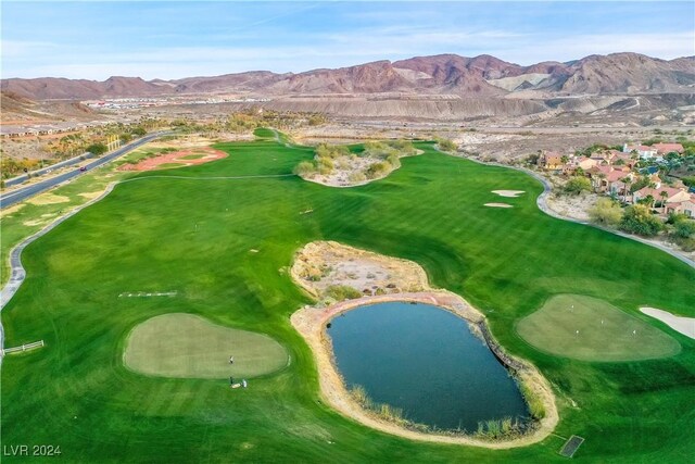 drone / aerial view featuring golf course view and a water and mountain view