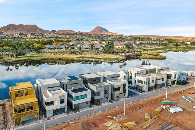 birds eye view of property with a water and mountain view