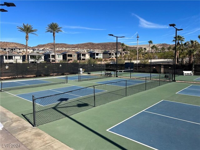 view of tennis court with a mountain view