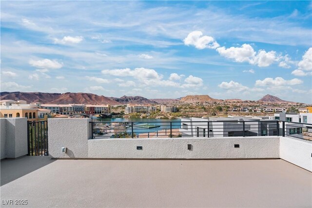 view of patio / terrace featuring a balcony and a water and mountain view