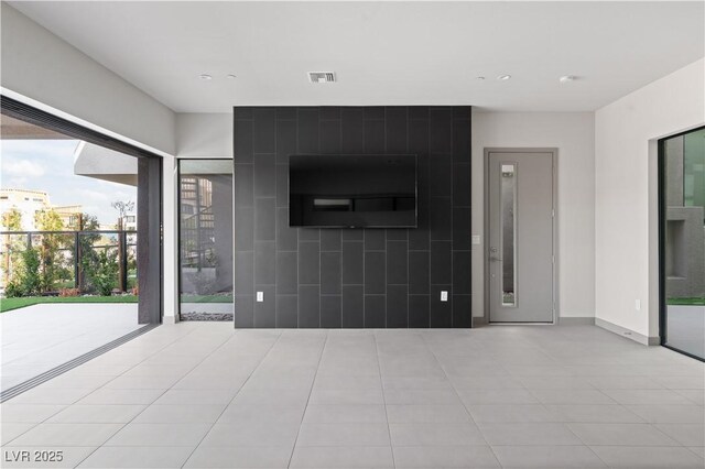 unfurnished living room with visible vents