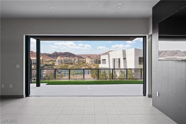 interior space with a mountain view and light tile patterned floors