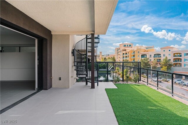 balcony featuring a water view and stairway