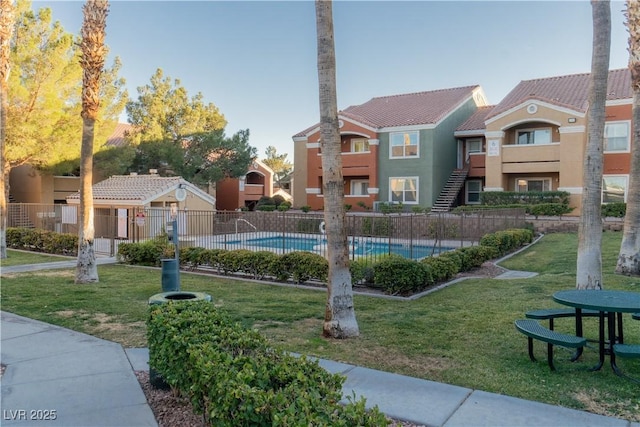 view of pool with a yard